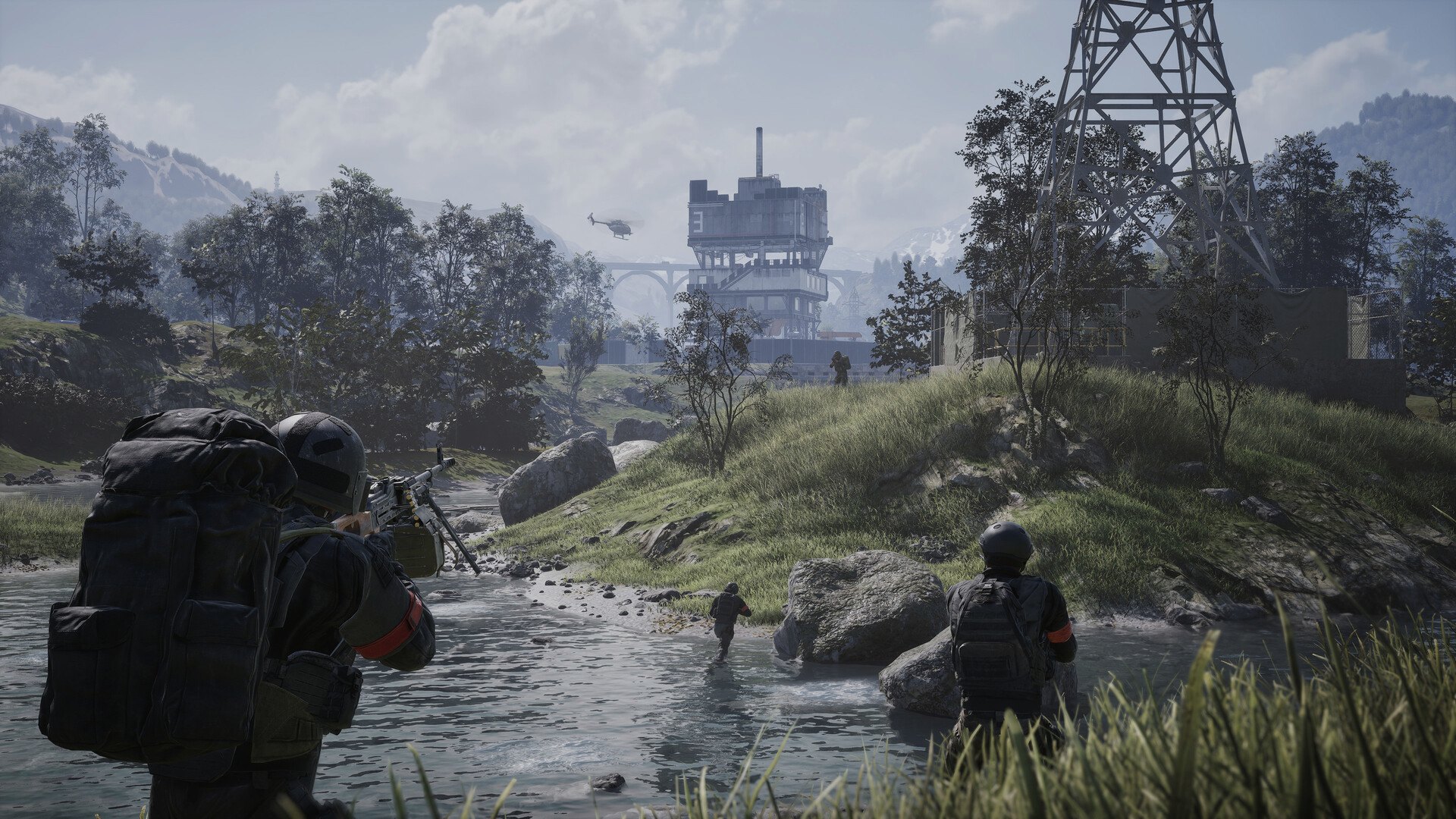 In-game screenshot: soldiers crossing a river below a derelict tower